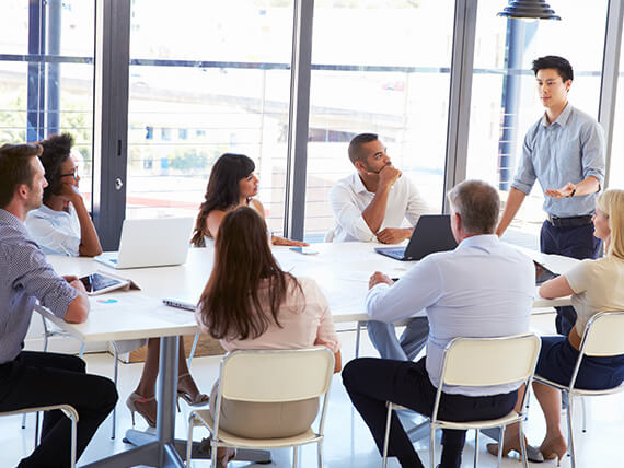 Businessman presenting to colleagues at a meeting